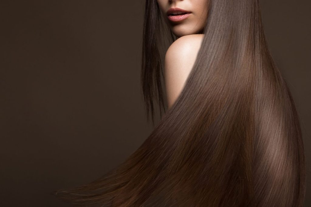 A woman with long hair is standing up