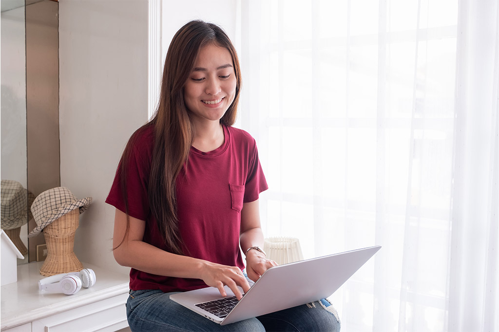 A woman sitting in front of a laptop computer.