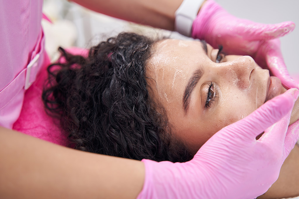 A woman is laying down with her eyes closed.