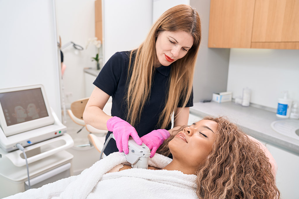 A woman is getting her teeth cleaned by a dentist.