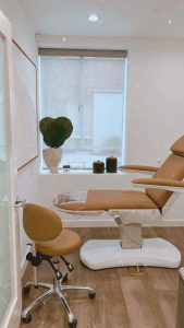 A chair and table in a room with a window.