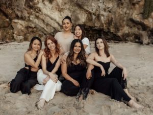 A group of women sitting on the beach