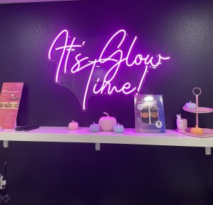 A shelf with some candles and a sign