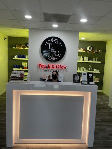 A person sitting at the counter of a store.